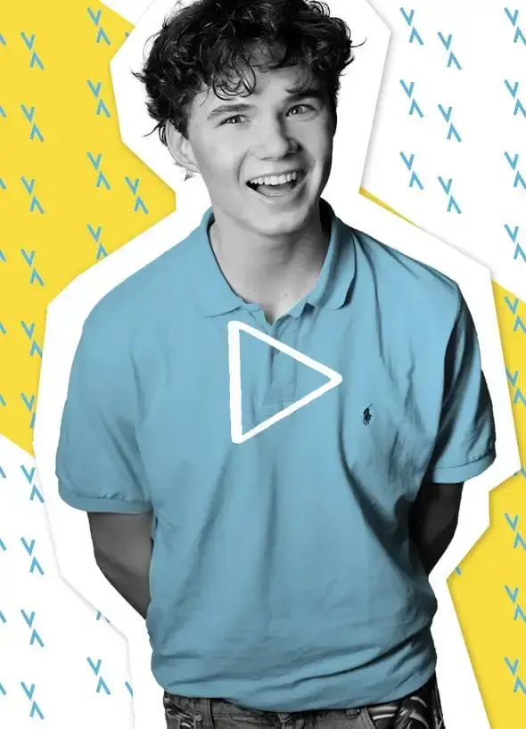 Ein lachender Jugendlicher mit lockigen Haaren und blauem T-Shirt